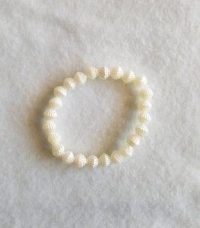 The Ivory Beaded Bracelet is an elegant and timeless accessory that adds a touch of sophistication to any outfit, with its delicate ivory beads and intricate craftsmanship.