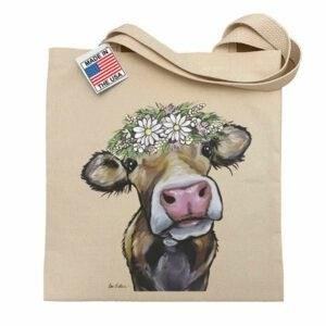 The Flower Crown Cow Tote Bag is a fashionable accessory that showcases a vibrant and whimsical design, perfect for adding a touch of fun to your everyday style.