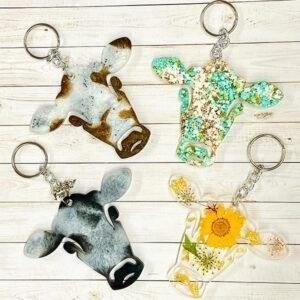 The Resin Cow Keychain is a cute and quirky accessory that adds a touch of fun to your everyday life. Made from high-quality resin, it features a detailed and realistic cow design that is sure to catch the eye. Attach it to your keys, backpack, or purse for a unique and whimsical touch. Whether you're a cow lover or just looking for a fun and unique accessory, the Resin Cow Keychain is the perfect choice.