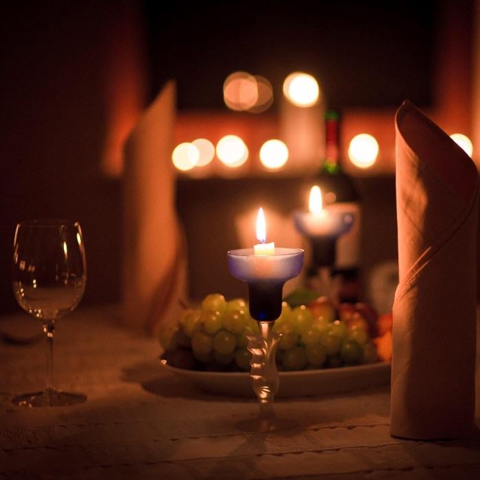 You can create a romantic atmosphere by having a candlelight dinner at home, enjoying a delicious meal together in the comfort of your own space.