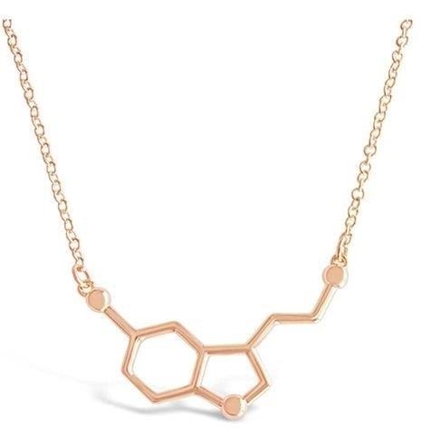 The Serotonin Molecule Necklace is a stylish and trendy accessory that represents the chemical compound responsible for happiness and well-being, making it a perfect gift for science enthusiasts or anyone looking to add a touch of intellect to their wardrobe.