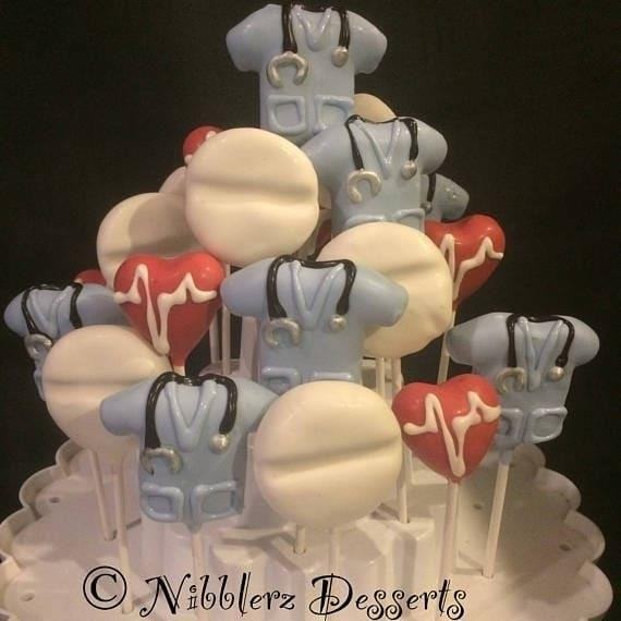 A Dozen Nurse Themed Cake Pops are delicious treats shaped like nurses, perfect for any medical-themed celebration or gift. They are made with moist cake, covered in smooth icing, and decorated with adorable nurse-inspired designs such as stethoscopes, syringes, and medical hats. These cake pops not only satisfy your sweet tooth but also bring a touch of medical professionalism to your dessert table. Whether you're celebrating a nurse's graduation, birthday, or simply want to show appreciation to the healthcare workers in your life, these nurse-themed cake pops are sure to be a hit!
