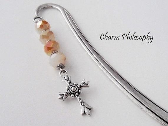 The Cross Beaded Bookmark is a stylish and functional accessory that adds a touch of elegance to any book, with its intricate beadwork and durable construction.