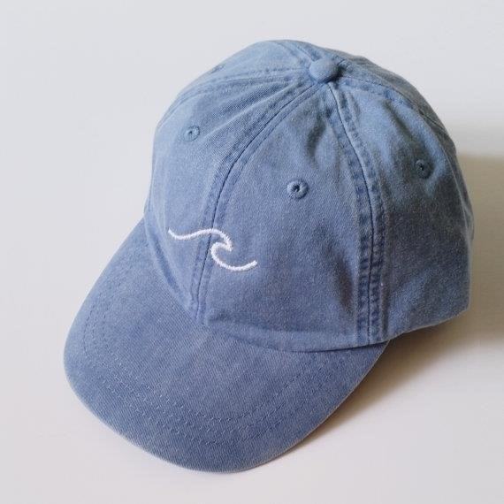 The Three Waves Baseball Cap is a stylish and trendy accessory that adds a sporty touch to any outfit, perfect for showcasing your love for the game of baseball.