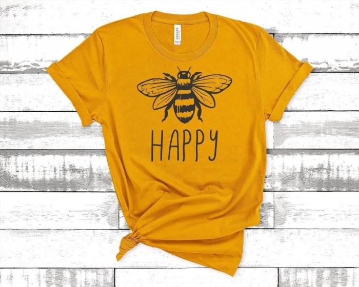 The Bee Happy T-Shirt is a vibrant and cheerful clothing item that spreads positivity and joy with its adorable bee design and uplifting message. It is the perfect choice for those who want to express their love for nature and embrace a happy and carefree lifestyle.