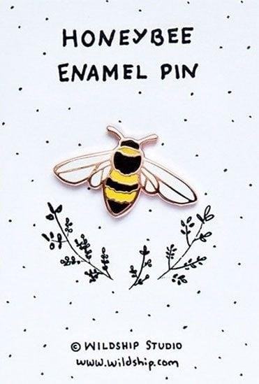 The Honey Bee Enamel Pin is a small accessory that can be worn on clothing or accessories, featuring a delicate design of a honey bee. It adds a touch of charm and style to any outfit, making it a popular choice among fashion enthusiasts. The pin is made of high-quality enamel, ensuring its durability and long-lasting shine. It can be a perfect gift for nature lovers or anyone who appreciates the beauty of bees.