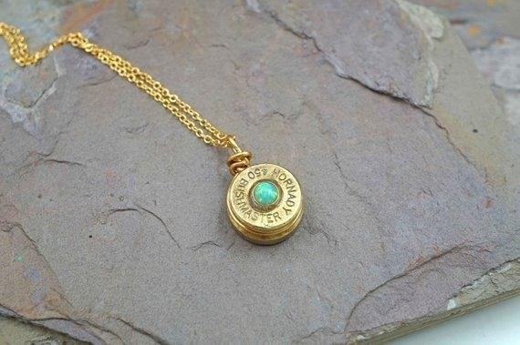 The Brass Bullet Necklace with Green Opal is a stunning piece of jewelry that combines the elegance of brass with the vibrant beauty of green opal, making it a perfect accessory for any occasion.