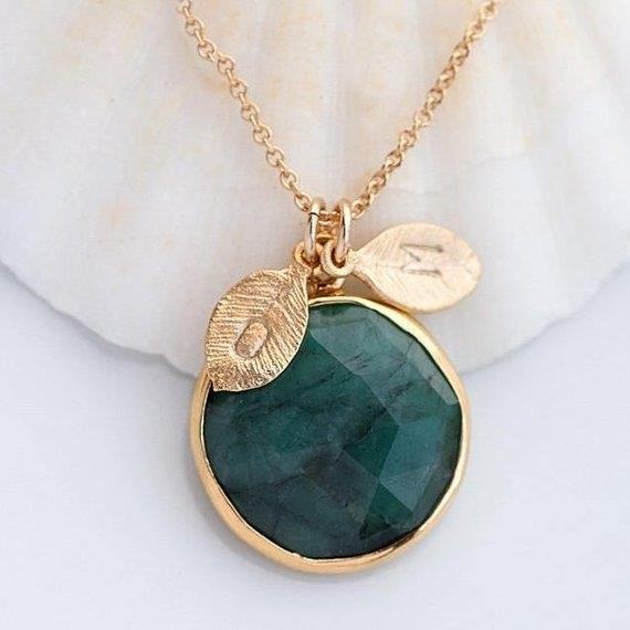 The Emerald Stone Necklace with Initials on Leaves is a stunning piece of jewelry that combines the beauty of emeralds with a personalized touch. The necklace features delicate leaves adorned with initials, adding a special and meaningful element to the design. It is a perfect choice for those looking for a unique and personalized accessory that exudes elegance and style.