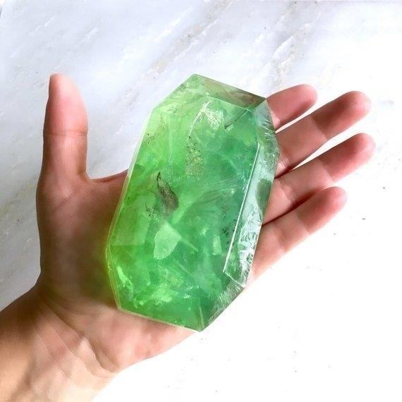 Emerald Gemstone Soap is a luxurious cleansing bar infused with the essence of precious emeralds, known for their rejuvenating and healing properties. Its enchanting fragrance and vibrant green color will transport you to a tranquil oasis, leaving your skin feeling refreshed and revitalized.