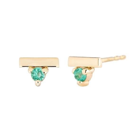 The Emerald Bar Stud Earrings are a stylish and elegant accessory that adds a touch of sophistication to any outfit. These earrings feature a stunning emerald bar design, showcasing the vibrant green color of the emerald gemstone. They are crafted with precision and attention to detail, ensuring a high-quality piece of jewelry. The stud style makes them easy to wear and comfortable on the ears. Whether for a special occasion or everyday wear, these Emerald Bar Stud Earrings are sure to make a statement and enhance your overall look.