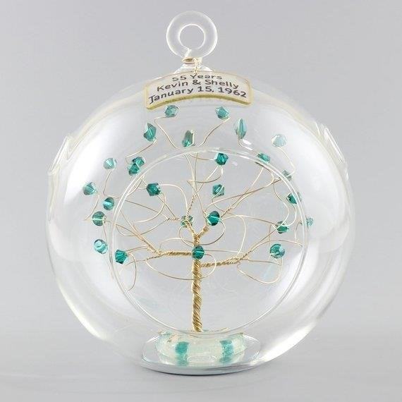 This personalized 55th Anniversary Ornament, adorned with emeralds on wire, is crafted in the shape of a tree, making it a stunning and meaningful keepsake to celebrate this milestone occasion.