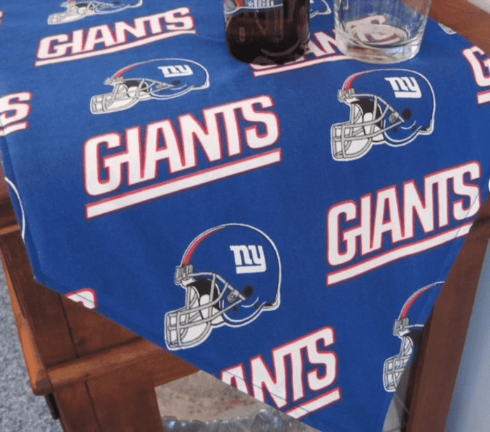 The New York Giants Table Runner is a stylish and practical addition to any football fan's home decor, showcasing the team's iconic logo and colors.