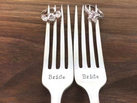 Handstamped Bride and Bride Wedding Forks are a personalized and charming addition to any wedding reception, allowing the happy couple to enjoy their first meal as newlyweds with a touch of elegance and sentimentality.