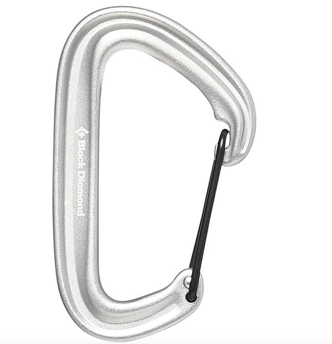 A real carabiner is a specialized type of metal clip used in rock climbing and mountaineering to securely connect ropes and other equipment, ensuring the safety of climbers during their ascent.