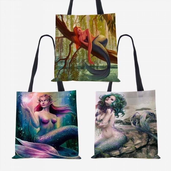 The Mermaid Tote Bag is a fashionable accessory that adds a touch of whimsy and charm to any outfit, perfect for carrying your essentials in style.