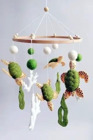 The Sea turtle baby crib mobile by TinylandUA is a charming and whimsical addition to any nursery, featuring adorable sea turtle designs that will captivate and entertain your little one.