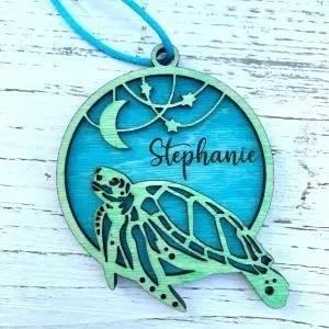 The personalized sea turtle ornament by Bigfoot Creations MN is a delightful and unique addition to any holiday decor or collection. Handcrafted with care, this ornament showcases the intricate details of a sea turtle, capturing its grace and beauty. Perfect for sea lovers or anyone who appreciates the wonders of marine life, this ornament is a must-have for your Christmas tree or as a thoughtful gift for a loved one.