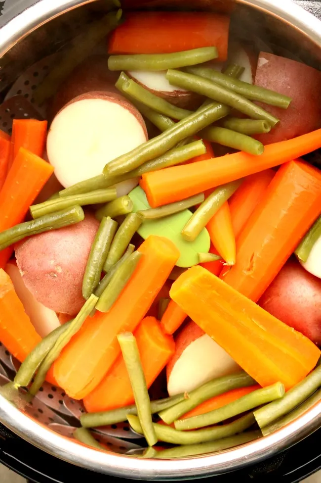 A steaming pot of colorful vegetables fresh out of the Instant Pot.