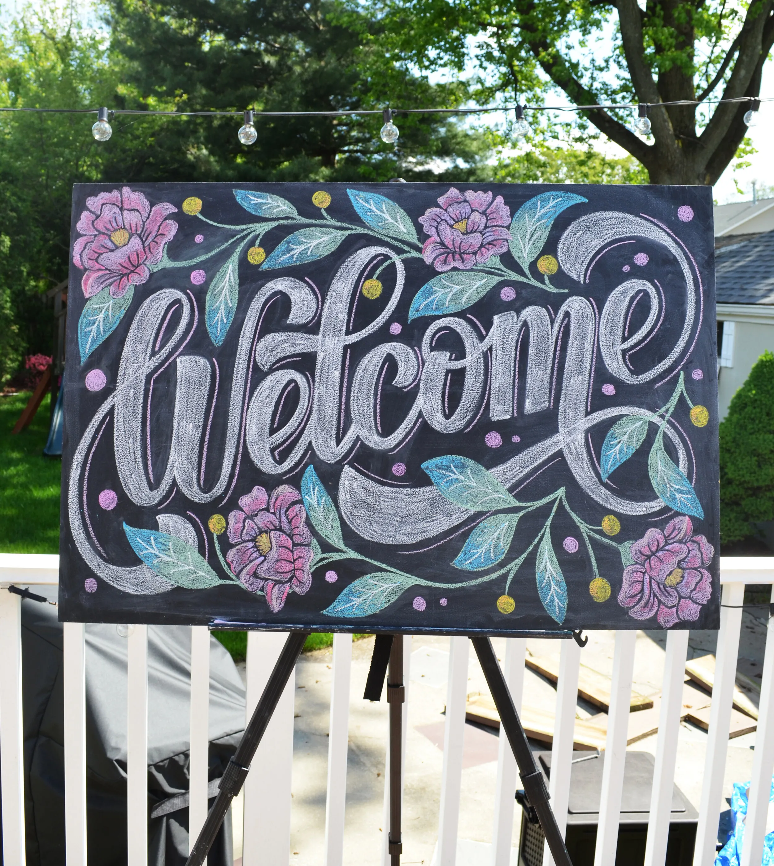 Finished Chalkboard with a welcome message and a plant.