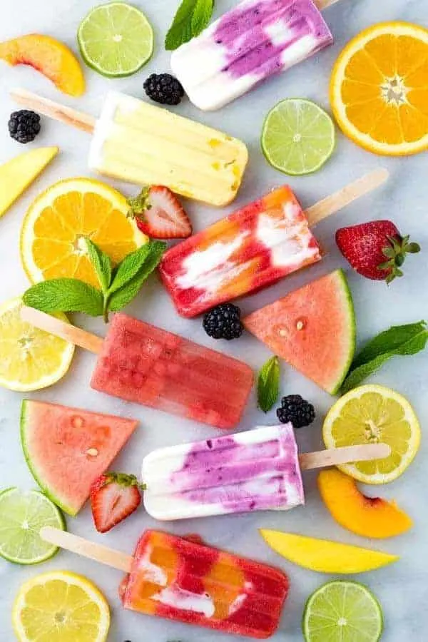 Healthy homemade fruit popsicles made with five ingredients or less! Four delicious recipes to choose from, strawberry, watermelon, lemon, and coconut.