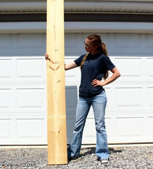 Shara Woodshop Diaries holding one board