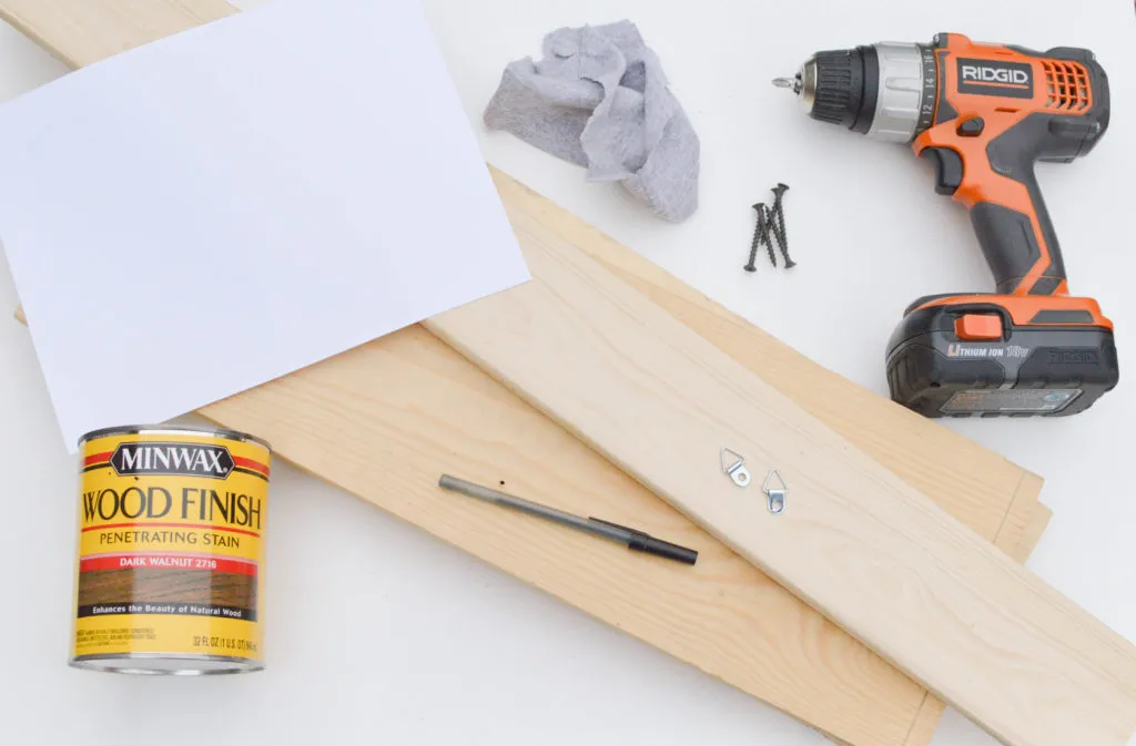 Transferring lettering onto a wood sign using a ballpoint pen.