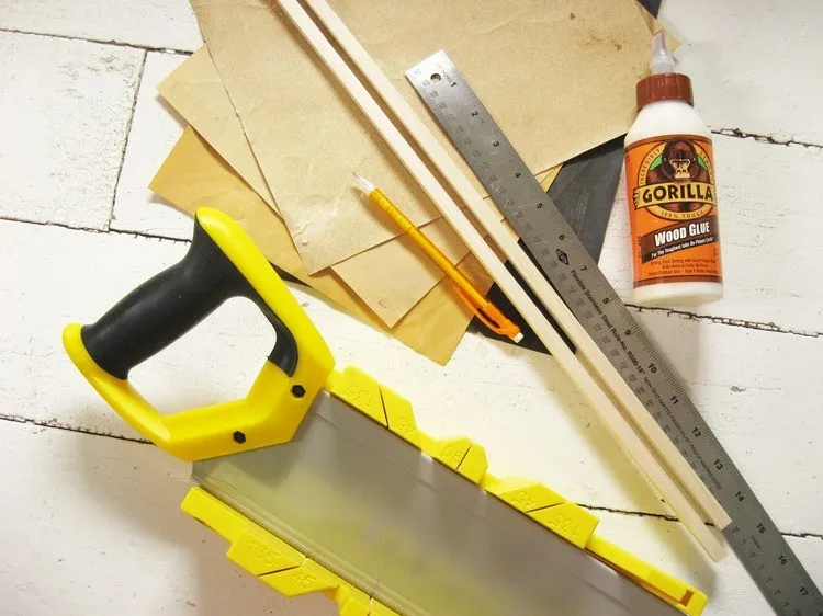 Wood dowel being cut on a miter box.