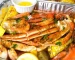 A delicious seafood bake with crab legs, shrimp, and corn.