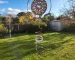 "A finished wind spinner hanging from a tree branch." width=