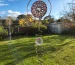 "A finished wind spinner hanging from a tree branch." width=