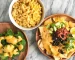 A plate of food with a bowl of macaroni and cheese, a plate of nachos, and a plate of broccoli.