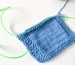 "Attaching the stitch holder cord to a knitting needle." class=