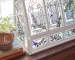 Clear glass greenhouse on a table with faux plants inside