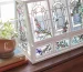 Clear glass greenhouse on a table with faux plants inside