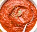 homemade pizza sauce in a bowl with a spoon