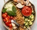 ingredients for one pot pasta arranged in cooking pan before cooking on marble background