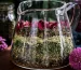 Layers of meditation tea herbs sit in a glass vessel