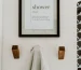 "Modern wooden wall hooks in a white entryway" class=