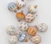 Painted earth tone wood ornaments on white background.