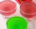 Red and green vegan jello in glass dishes.